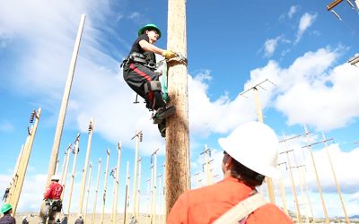 A student gets a gets a sense for what it's like to be a lineman at a Trades and Technology Day at Montana Tech's Highlands College. Photo courtesy of Montana Tech.