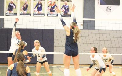 Logan McKay, left, tips the ball over the outstretched arms of a Dillon defender as teammates Faith Stainer (3), Addie Olson (20) and Jorie Olson (8) follow the action during the Lady Copperheads' home loss to Beaverhead County on Thursday, Sept. 10. Anaconda Weekly Review photo by James S. Rosien.